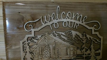 Welcome to our cabin wooden sign, with mountains in back ground
